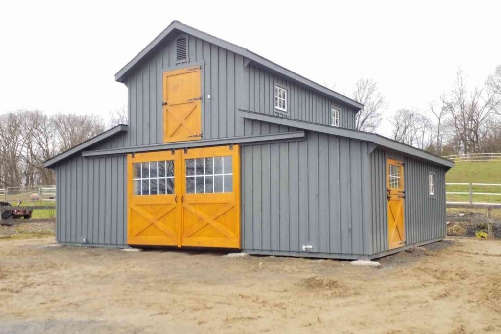 new construction gray two-tone barn Two story two-tone barn with gray and natural wood