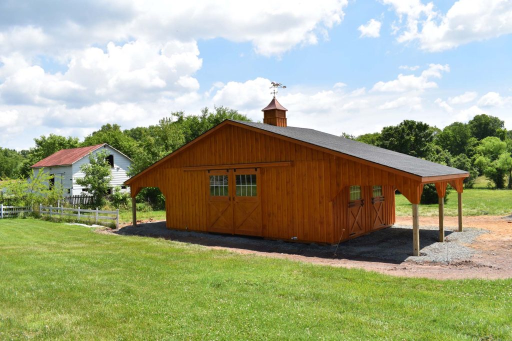 Center aisle horse barn with overhangs