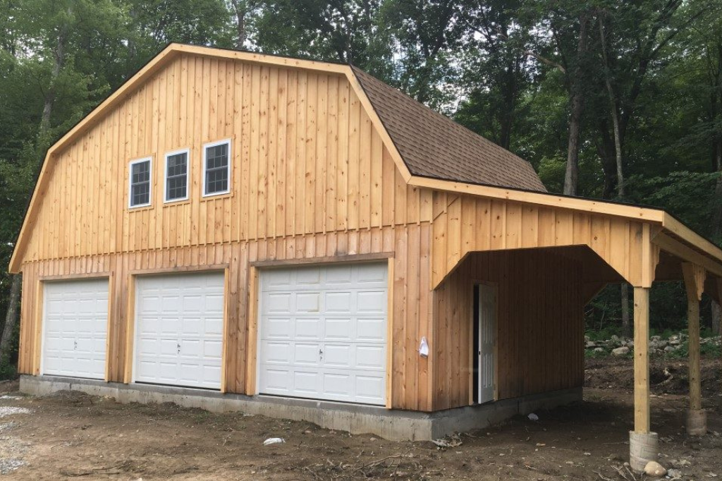 garage with a second story and 3 doors
