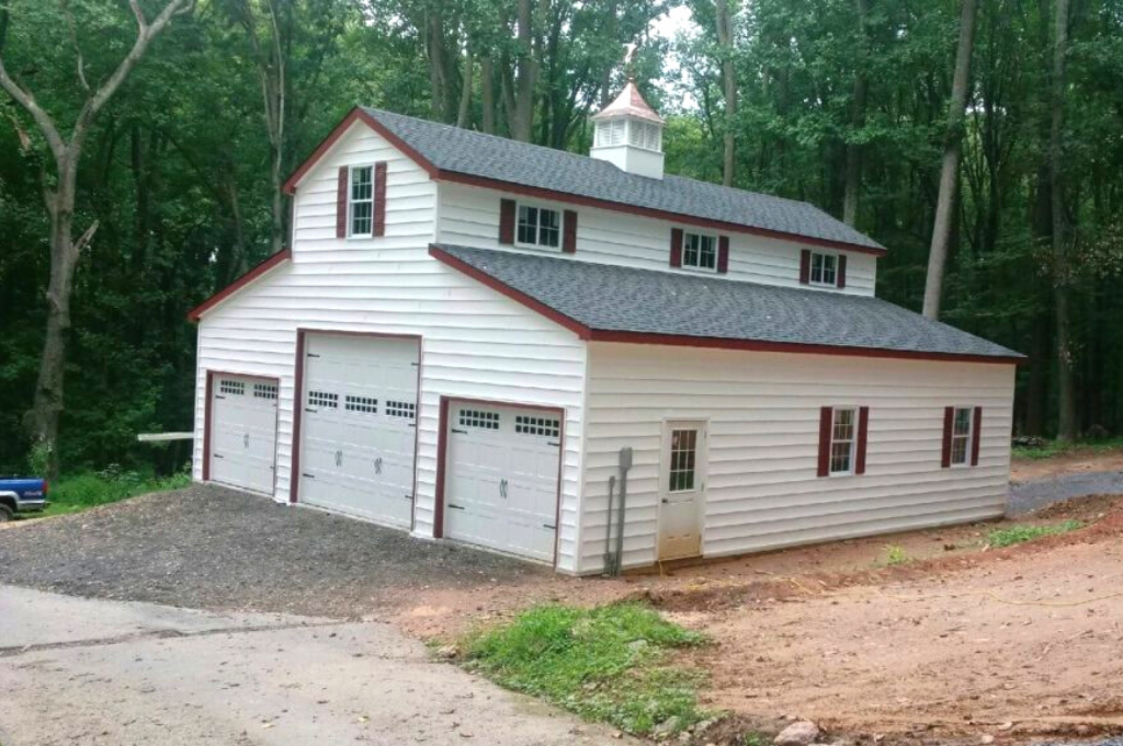 Barn style garage with white paint and red trim