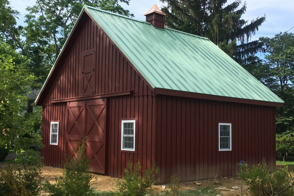 Red outdoor storage barn in woods