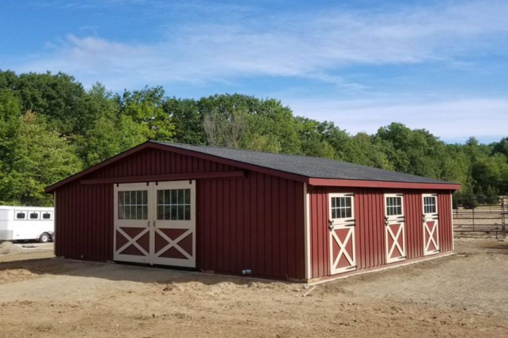 Simple red stained barn with white trim