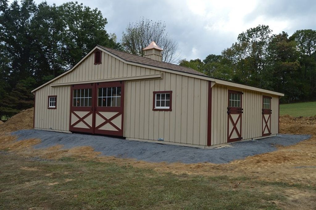 Two tone equine barn with center aisle 