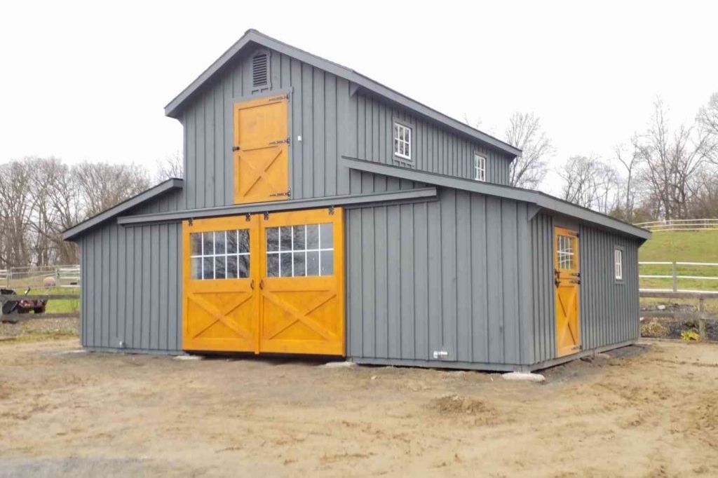Two story two-tone barn with gray and natural wood 