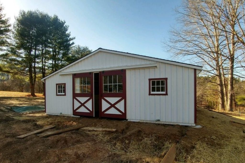 Two tone barn with white siding and red trim