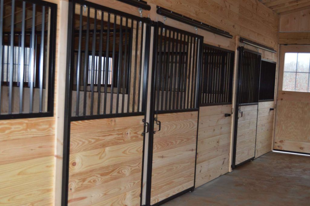 modern black barn interior with horse stalls
